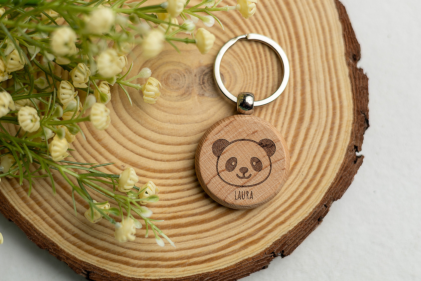 Llavero de madera redondo personalizado Laura con diseño de oso panda.